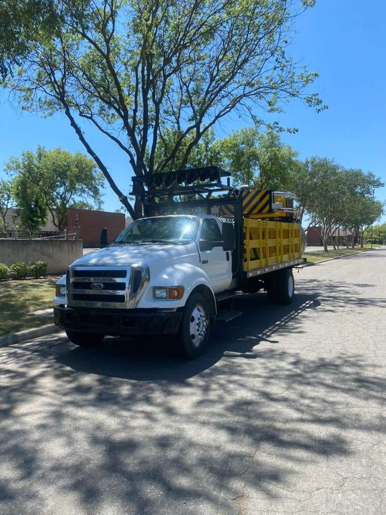 2016 Ford F-650 flatbed with folded truck-mounted attenuator